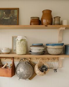 some shelves with pots and pans on them