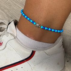 🌸 Turquoise and navy blue turtle miracle bead anklet (4mm) 🌸  ♥️Catches the light to give off a glow!  ♥️Perfect for nights out or even holidays!  ♥️Please message me if you have any questions each  ♥️ All anklets are made on rope. The two ends will need to be tied together and in a double knot so that the anklet does not come off. These are safe to wear in water.  Also available with matching bracelets, earrings and chokers! The colour may vary slightly due to most images being taken under direct sunlight or with flash to show you the full effect of the beads x  White beads may appear grey/silver when opened in a dark room. The full effect of the beads will shine through in different lights. Please note: Buyer pays for any return postage/ exchange postage x Blue Round Beads Anklets For Gifts, Blue Anklets With Round Beads For Gift, Bead Anklet, Blue Turtle, Beads Bracelet Design, Beaded Anklets, Anklet Jewelry, Matching Bracelets, White Beads