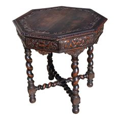 an old wooden table with ornate carvings on the top and legs, isolated against a white background