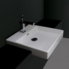 a white sink sitting on top of a black counter