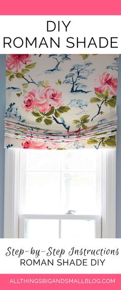 a white window with pink flowers on it and a blue wall behind the window sill