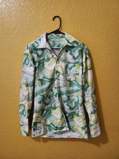 Vintage men's button shirt. large collar with really cool outdoorsy scene with a man and woman dancing. iridescent buttons  no brand or size information, but shirt fits like a men's Medium Fitted Green Collared Camp Shirt, Spring Long Sleeve Camp Shirt, Spring Long Sleeve Camp Shirt With Buttons, Long Sleeve Camp Shirt With Graphic Print For Spring, Fitted Collared Camp Shirt For Spring, Fitted Button-up Camp Shirt For Spring, Fitted Collared Spring Camp Shirt, Fitted Spring Button-up Camp Shirt, Fitted Green Shirt With Camp Collar