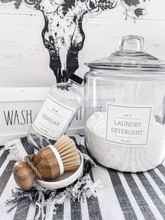 the contents of a bath and body care product displayed on a striped tablecloth in front of a deer head