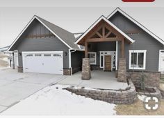 this is an image of a house in the snow with two garages on each side