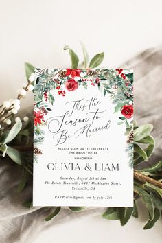 an elegant floral wedding card with greenery and red flowers on the front is shown