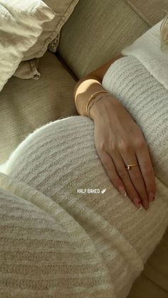 a woman's hand resting on the back of a couch