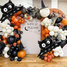 two halloween wreaths made out of balloons with bats, pumpkins and other decorations