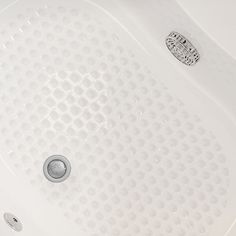 a white bath tub sitting next to a shower head