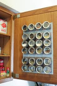 an open wooden cabinet with spices and condiments