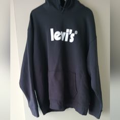 Levi Relaxed Logo Hoodie Sweatshirt: Made From Soft Fleece 80% Cotton, 20% Polyester Drawstring Hood Long Sleeve Kangaroo Pockets Casual Crew Neck Outerwear With Logo Print, Levi's Long Sleeve Winter Sweatshirt, Levi's Black Long Sleeve Tops, Levi's Long Sleeve Sweatshirt For Fall, Levi's Cotton Sweatshirt For Fall, Levi's Casual Sweatshirt For Fall, Levi's Cotton Sweatshirt For Winter, Levi Jean Jacket, Black Corduroy Jacket