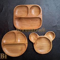 three wooden trays with mickey mouse ears on them, one is empty and the other has