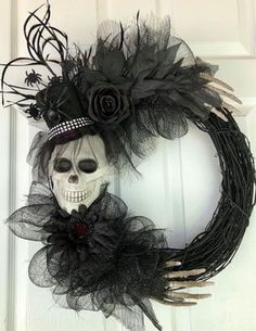 a wreath with a skull and flowers on it