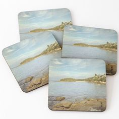 four coasters with an image of the ocean on them