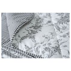 the comforter has black and white flowers on it, while the sheets are striped