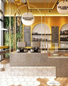 the interior of a coffee shop with yellow and white walls, marble countertops, and gold accents