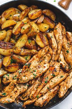 chicken and potatoes in a skillet with parsley