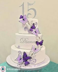 a white cake with purple butterflies on it and the number fifteen is decorated in silver