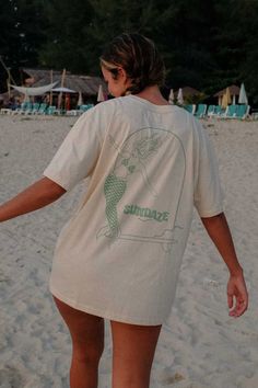 Model posing at the beach from the back, showing her t-shirt with mermaid illustration Bespoke Illustration, Big Tshirt, Surf Suit, How To Measure Yourself, Cheeky Bikinis, Large Bust, The Outdoors, Positive Vibes, Oats