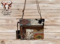 This purse is just the right size to hold all your daily needs. It features a beautiful patchwork pattern of patterned rugs embossed leather and a brown and dark brown cowhide sections.  The front has a zippered section for additional storage.  The back is recycled canvas. The leather strap is adjustable, so you can use it as a shoulder bag, or adjust the length and use it as a crossbody. There is also a removable hand strap if you prefer to carry it that way, as the shoulder strap is removable Brown Patchwork Rectangular Bag, Brown Rectangular Patchwork Bag, Rectangular Brown Patchwork Bag, Brown Rectangular Patchwork Shoulder Bag, Rustic Brown Crossbody Bag, Rustic Brown Rectangular Shoulder Bag, Myra Bags, Patterned Rugs, Brown Cowhide