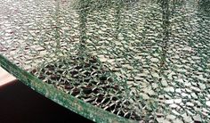 a close up view of a green table with broken glass on it's surface