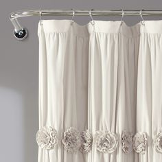 a curtain with flowers on it hanging from a rod