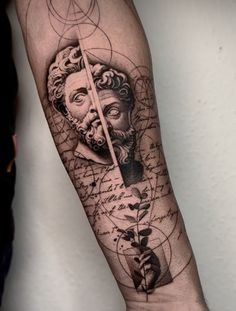 a man's arm with an artistic tattoo on it