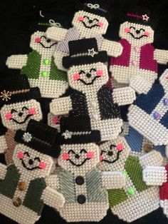 a pile of beaded snowmen sitting next to each other