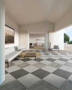 an empty room with checkered flooring and furniture