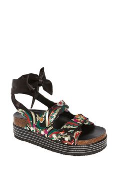 These black floral printed platform sandals feature a trendy slip on design with a black ribbon tie ankle closure. The black sole boasts white stitching for a touch of contrast. Perfect for adding a chic touch to any outfit. Platform Height: 1.5" Black Casual Platform Lace-up Sandals, Casual Black Platform Lace-up Sandals, Black Adjustable Platform Wedge Sandals, Black Platform Lace-up Sandals For Beach, Adjustable Black Platform Wedge Sandals, Black Platform Lace-up Sandals For Summer, Black Platform Lace-up Summer Sandals, Azalea Wang, Flatform Sandals