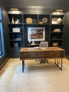 a home office with built - in shelving and desk