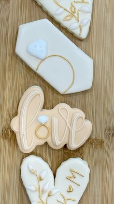 three decorated cookies sitting on top of a wooden table