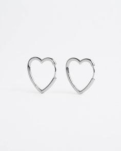 Devotional holds honoured. For all romantiques to wear love lite. Heart-shaped earrings with a seamless clicker mechanism and a high-polished finish. Available in 3 hoop sizes – small for a closer fit, medium to match any style or large for louder looks. Sold as a pair. Style & Material Style: Hoop Earrings Base material: 925 silverNickel-free: Yes Gold Coating: 14K gold plating Silver Coating: None Measurements (per piece) Small Height: 10mm Thickness: 2.4mm Weight: 1.4 grams Medium Height: 14m Everyday Heart-shaped Huggie Earrings In Sterling Silver, Everyday Heart-shaped Sterling Silver Huggie Earrings, Silver Heart-shaped Hypoallergenic Huggie Earrings, Silver Hypoallergenic Heart Huggie Earrings, Silver Huggie Heart Earrings For Everyday, Heart-shaped Sterling Silver Huggie Earrings, Sterling Silver Heart Shaped Huggie Earrings, Sterling Silver Heart-shaped Huggie Earrings, Heart-shaped Sterling Silver Huggie Earrings For Valentine's Day