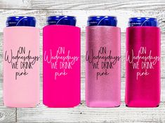 three pink and blue can coolers with the words on them