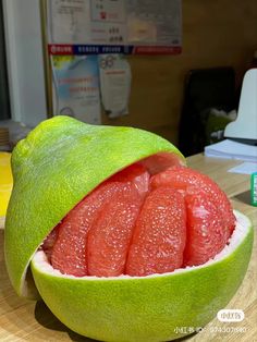 a grapefruit cut in half sitting on top of a table