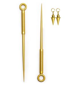 two pairs of gold colored metal scissors and a pair of brass colored screws on a white background