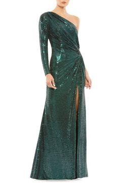 Glistening sequins make a stunning statement on an emerald-green gown that's gathered at the side and finished with a one-shoulder neck and soaring front slit. 63" length One-shoulder neck Single long sleeve Lined 100% polyester Spot clean Imported Asian Owned/Founded Emerald Green Gown, Vestidos Color Coral, Stylish Gown, Fitted Gowns, Drape Gowns, Sequin Formal Dress, One Shoulder Gown, Silvester Party, Column Dress