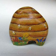 a wooden beehive with bees painted on it