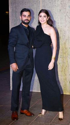 two people standing next to each other in formal wear