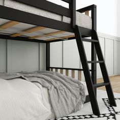 there is a bunk bed with a ladder on the bottom and a rug underneath it