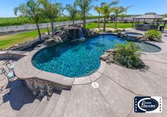 a backyard with a pool and patio furniture