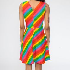 "Vintage 70s dress in rainbow stripes. Sleeveless with a high waist and a rear zip. Mini length. Every garment we sell is authentic vintage and one-of-a-kind! You will receive the exact item photographed. Condition: Very good vintage. Best fits women's: Extra small, 25\" waist no stretch Tag: gay gibson Material: Polyester MEASUREMENTS Taken from seam to seam while the garment is lying flat. Double the armpit, waist, and hips For reference, model is 5'10\" and measures 32-23-34. Length from Top: Retro Multicolor Sleeveless Dress For Spring, Retro Striped Mini Dress, Multicolor Sleeveless Mod Dress, Multicolor Retro Sleeveless Mini Dress, Retro Multicolor Sleeveless Mini Dress, Rainbow Sleeveless Dress, Fitted Retro Multicolor Sleeveless Dress, Multicolor Retro Sleeveless Dress, Retro Multicolor Sleeveless Dress