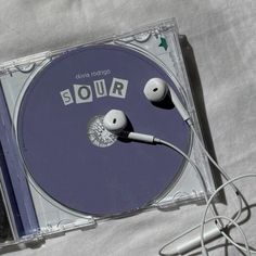 a pair of headphones sitting on top of a clear cd case with the word sour written on it