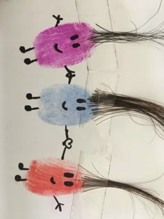 three children's handprints with different colored hair