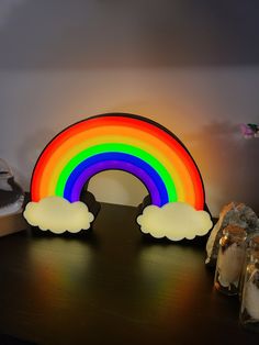 a wooden table topped with a rainbow and clouds