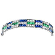 Art Deco inspired bracelet set in platinum that features a 4.16 carats of green emerald, 4.25 carats of diamond, 10.82 carats of blue sapphire. Sophia D has been known world-wide for over 40 years because of its rich history of design and quality craftsmanship. From art deco to antique reproduction, these timeless pieces, when merged with modern manufacturing techniques, create a perfect harmony between old and new Gem Bracelets, Art Deco Emerald, Emerald Blue, Art Deco Bracelet, Gems Bracelet, Gold Bracelets, Green Jewelry, Perfect Harmony, Art Deco Inspired