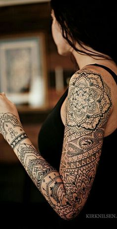 a woman with many tattoos on her arm