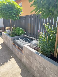 a concrete planter filled with lots of plants