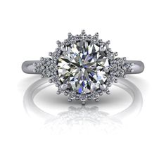 a white gold engagement ring with an oval cut diamond surrounded by round brilliant pave diamonds