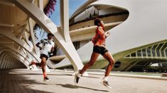 two men are running in front of a building