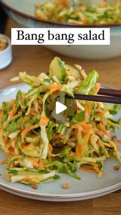 a white plate topped with salad and chopsticks